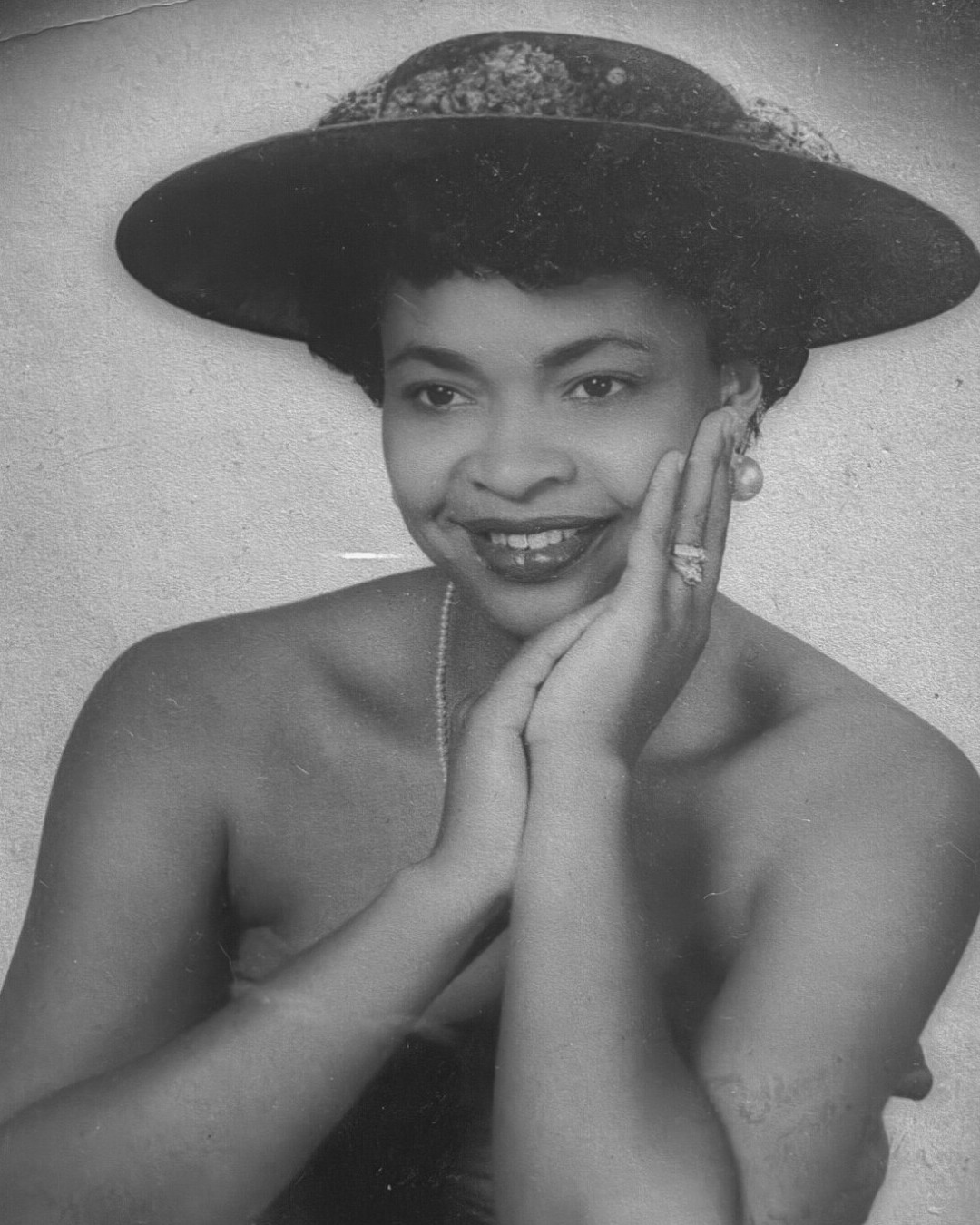 A black-and-white vintage portrait of a young Barbra Hazely wearing a wide-brimmed hat
